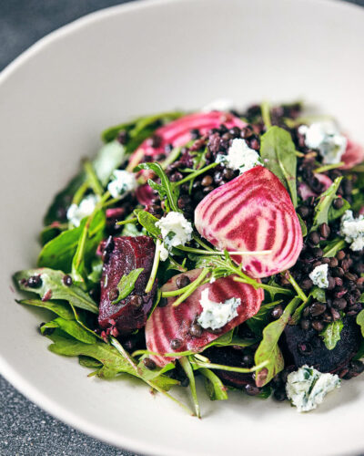 Close up of beet and lentil salad in a white bowl