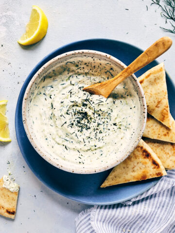 Bowl of vegan tzatziki with bread for dipping