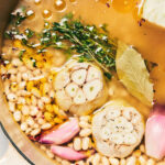 Dutch oven with beans, garlic, rosemany shallots and other ingredients