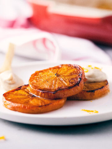 Caramelized persimmons topped with vanilla maple cream and orange peels