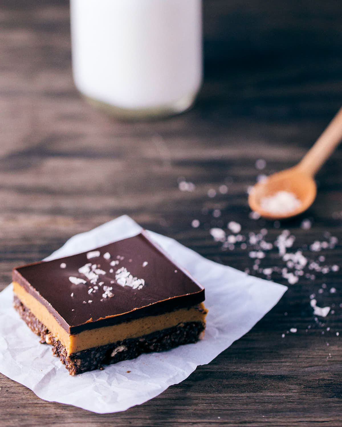 Chocolate peanut butter bars being topped with sea salt