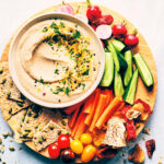 Platter with fresh veggies, crackers and white bean dip