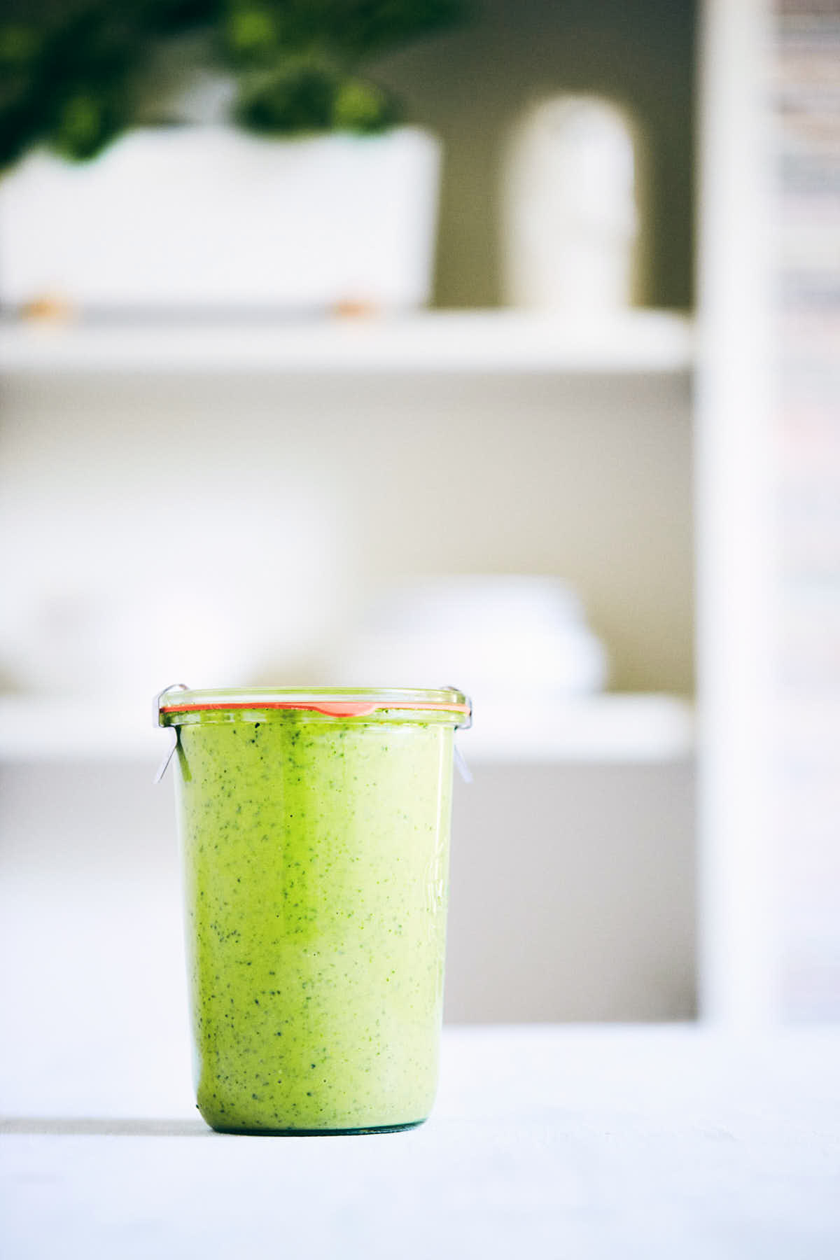 Pea pesto sauce in a tall storage container