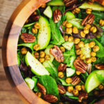 Serving bowl of curry apple salad with spiced chickpeas after being mix