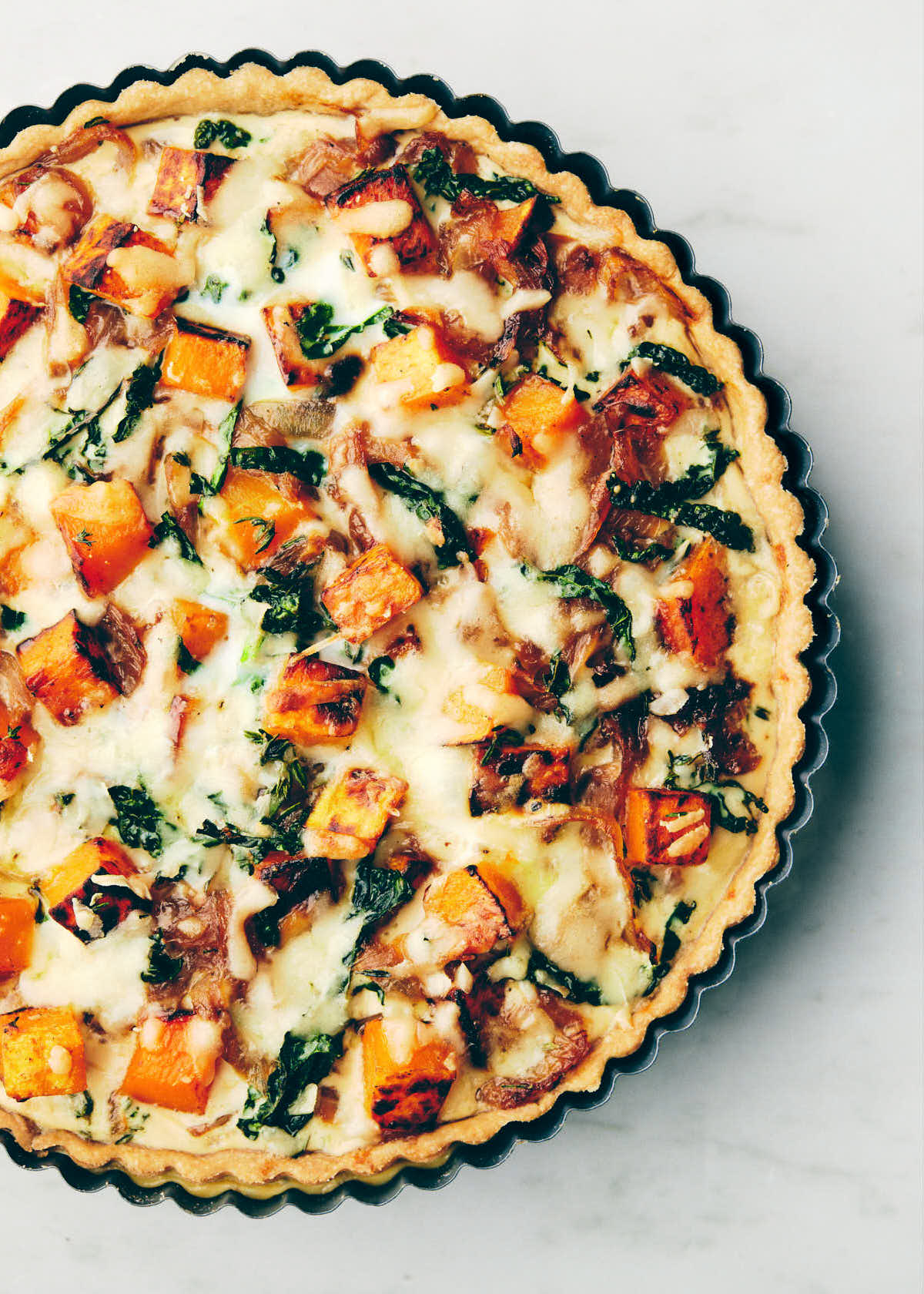 Baked butternut squash and cheese quiche on the counter