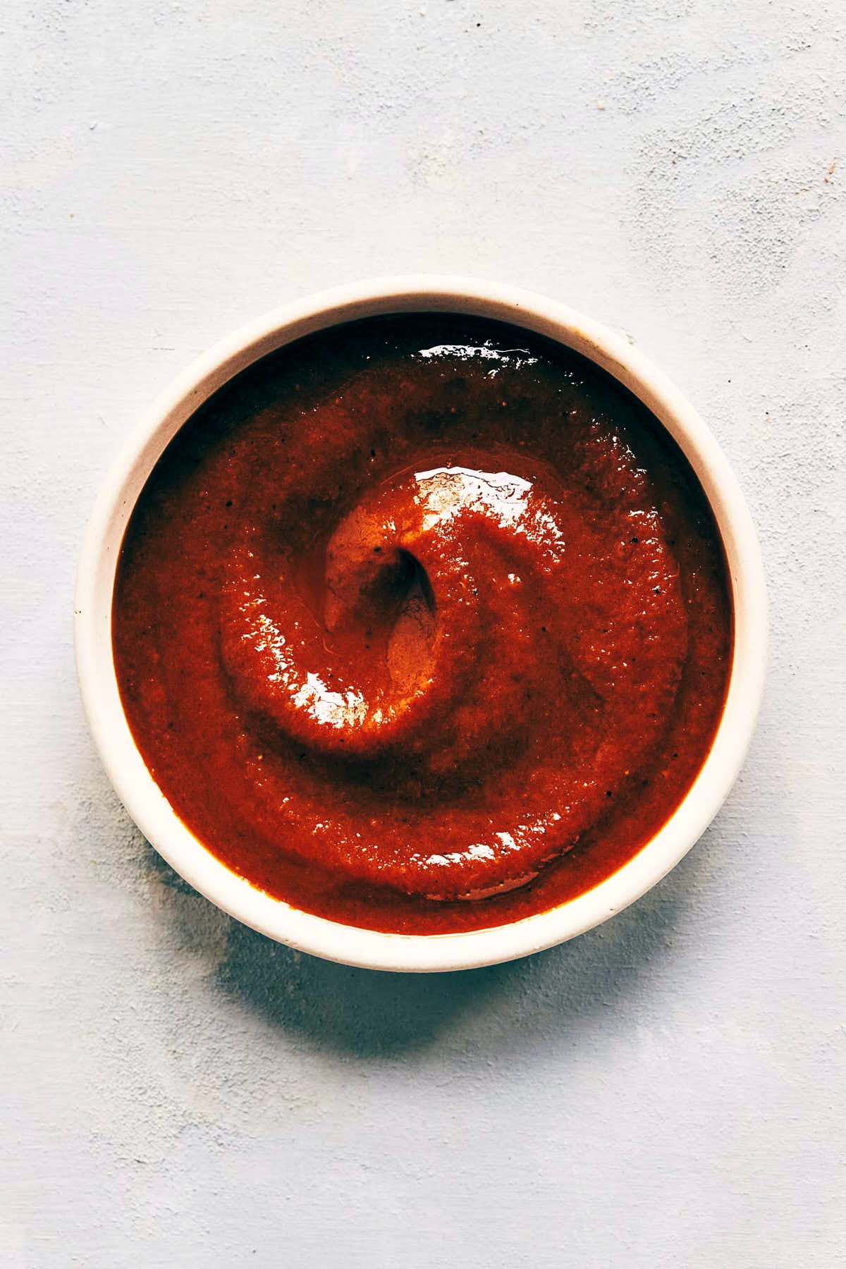 Close up on bowl of homemade barbecue sauce after it has been used