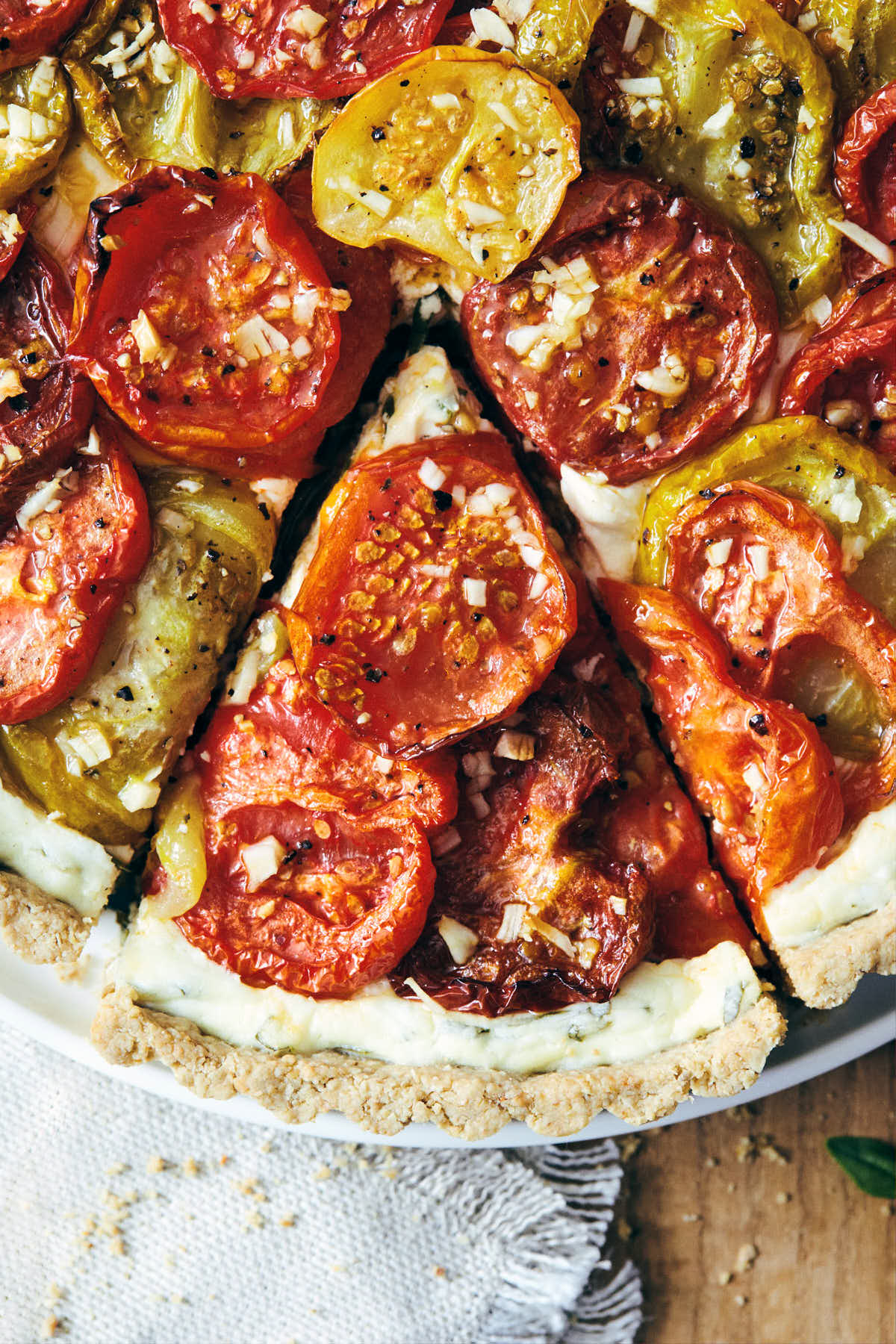 Heirloom tomato tart fresh out of the oven with a slice cut out