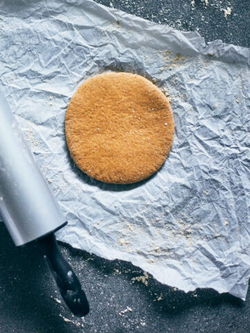 Rolled out dough for whole grain pita bread on a piece of parchment paper