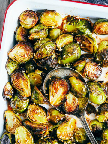 Close up of cooked maple sriracha brussels sprouts fresh out of oven