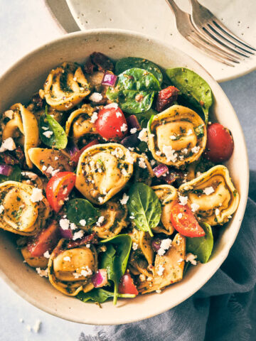 Bowl of tortellini topped with feta and veggies