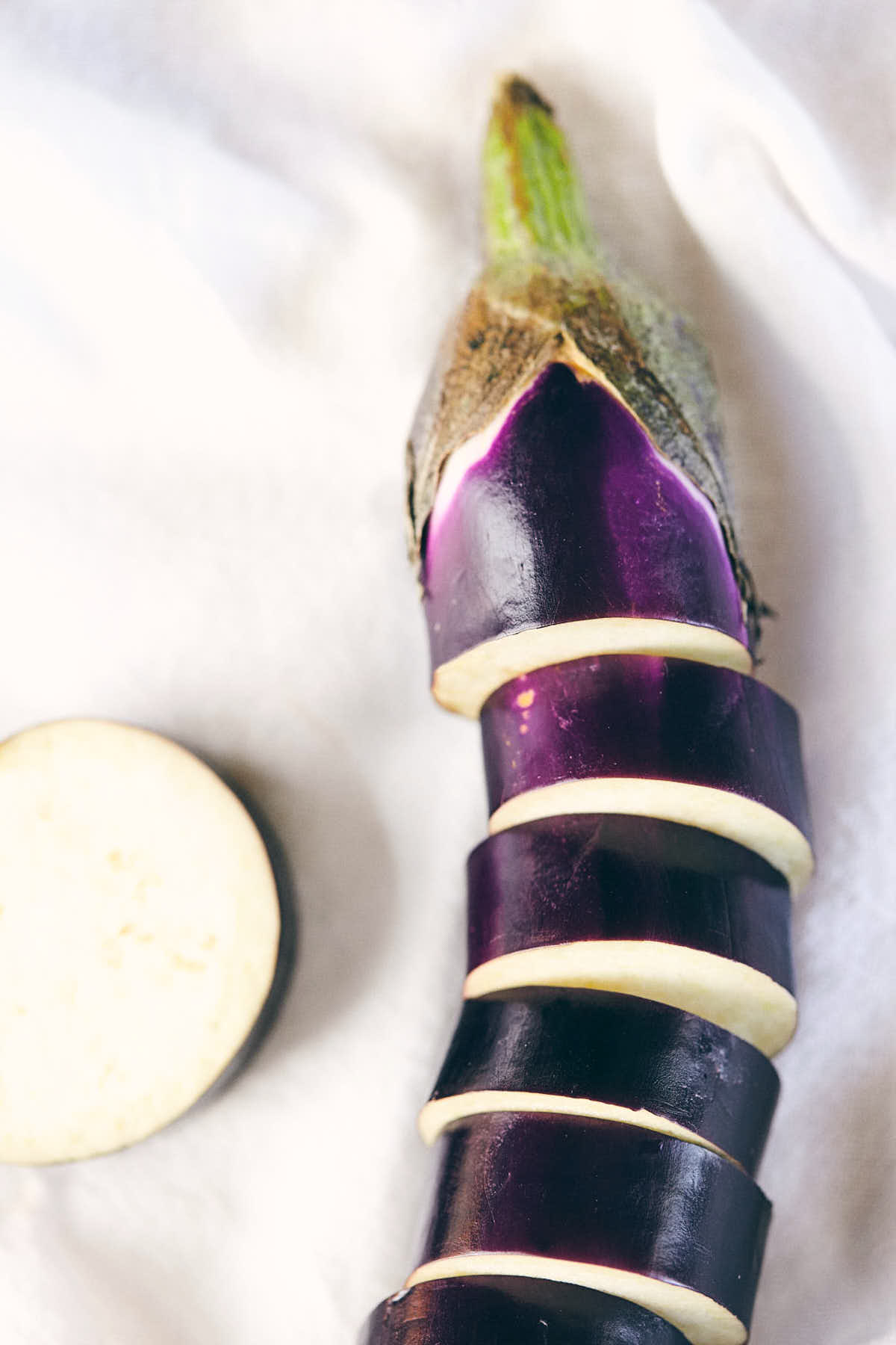 Japanese eggplant cut into segments for skewering