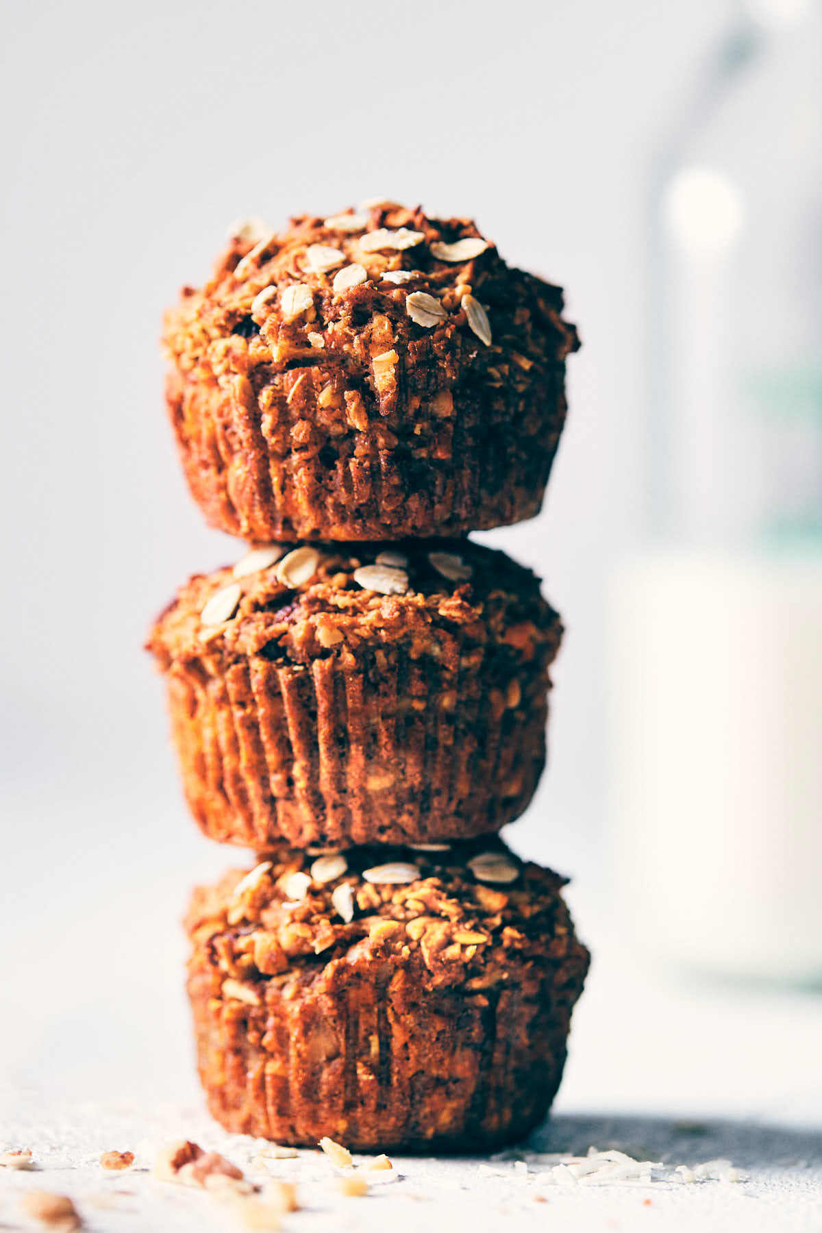 Stack of morning glory muffins with milk in the background