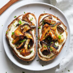 Close up plate of shiitake and chanterelle mushrooms on toast