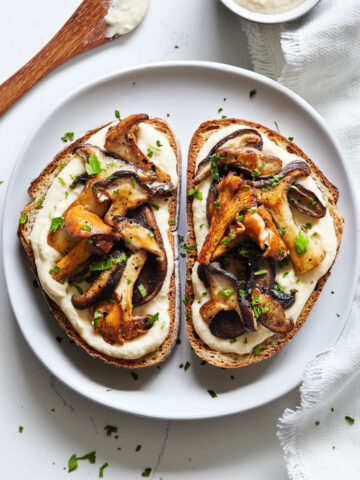 Close up plate of shiitake and chanterelle mushrooms on toast