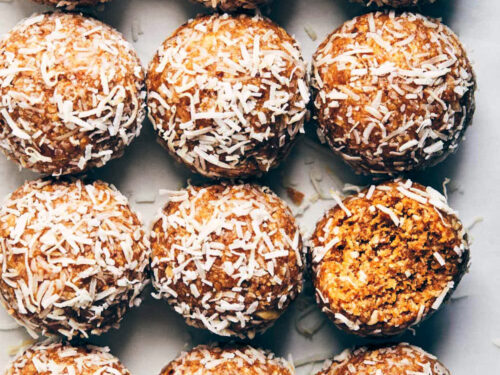 12 peanut butter coconut power balls on a marble background