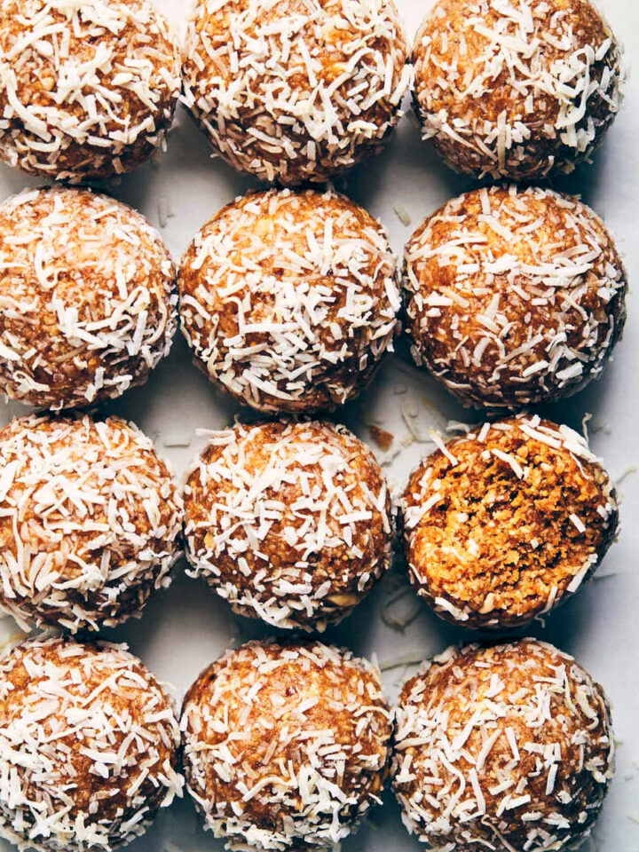 12 peanut butter coconut power balls on a marble background