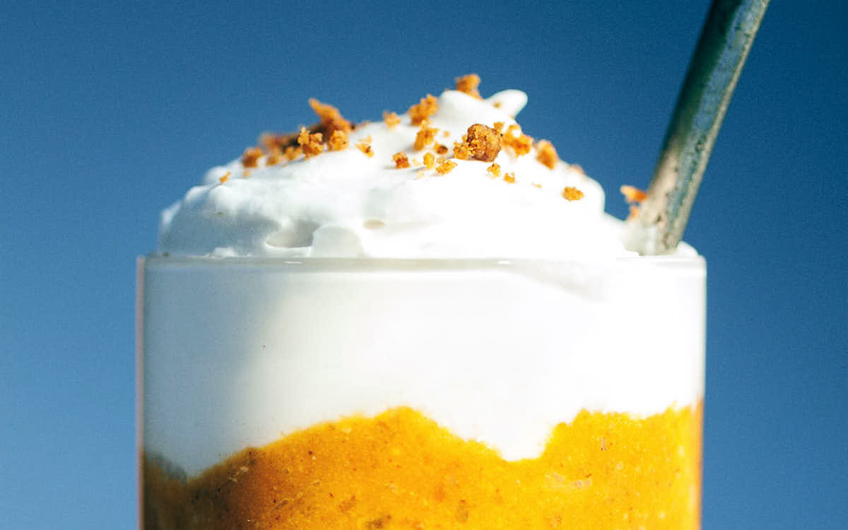 Close up of pumpkin pie parfait with a spoon digging in
