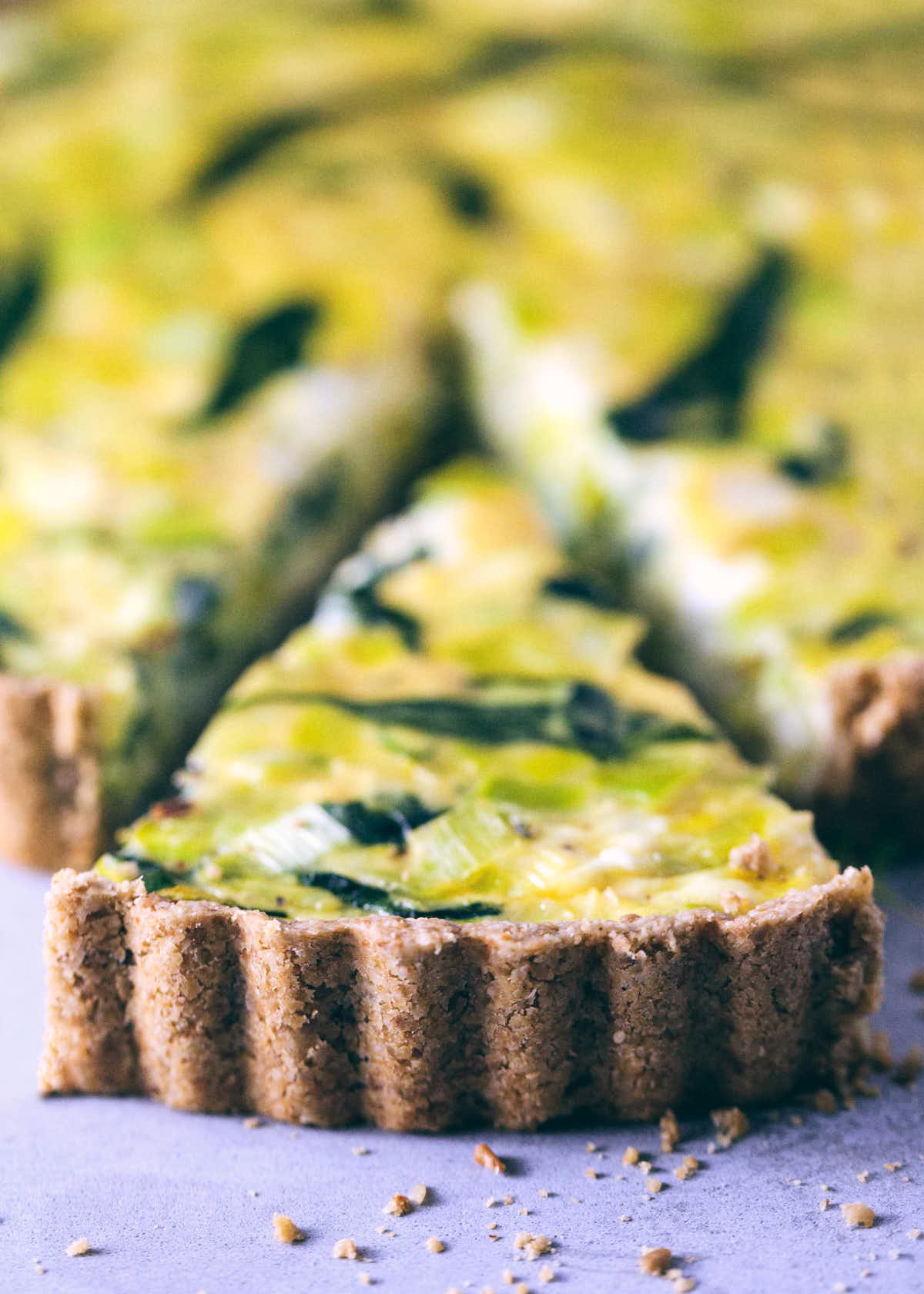 Slice of quiche on a stone surface