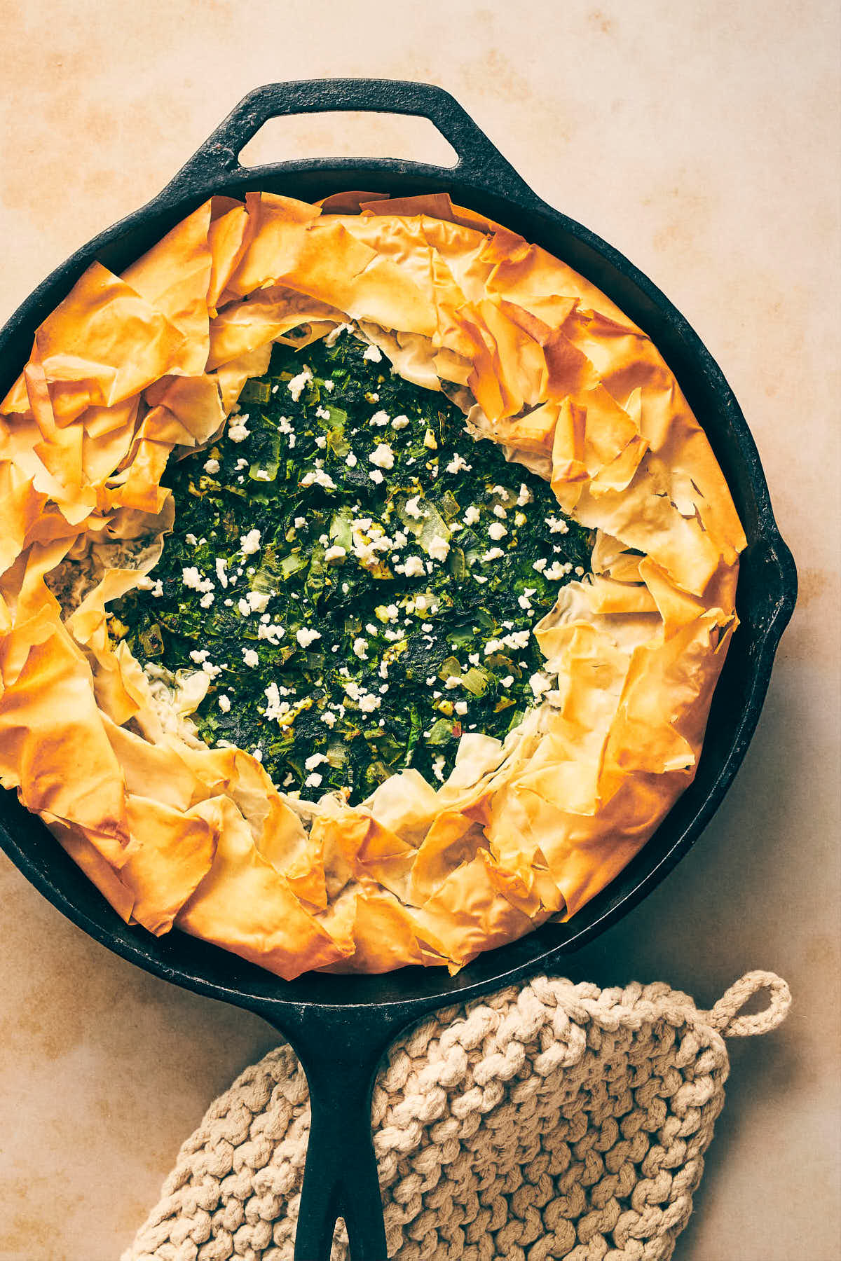 Cooked spanakopita sitting on the counter in a cast iron pan
