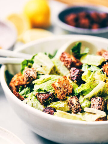 Close up of vegan Caesar salad topped with parmesan and croutons