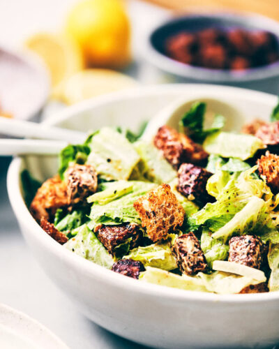 Close up of vegan Caesar salad topped with parmesan and croutons