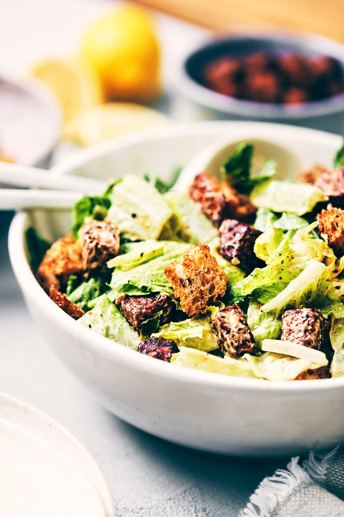 Close up of vegan Caesar salad topped with crispy croutons 