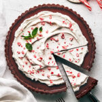 Chocolate peppermint tart topped with candy cake and sliced