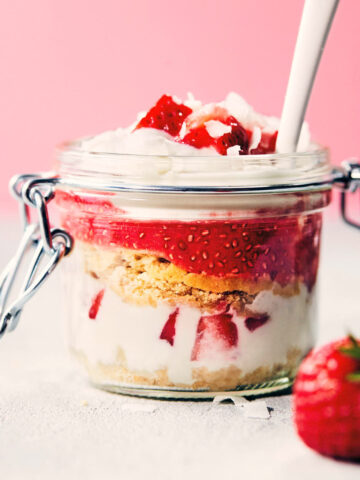 Strawberry shortcake trifle on a counter with a white spoon