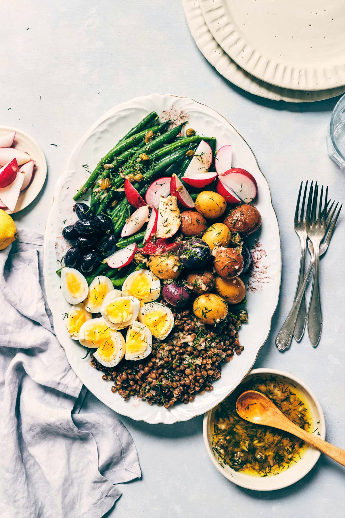 Nicoise salad with eggs, roasted potatoes, green beans, lentils and fresh radishes