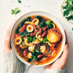 Veggie bean soup topped with roasted lemon topped with parsley