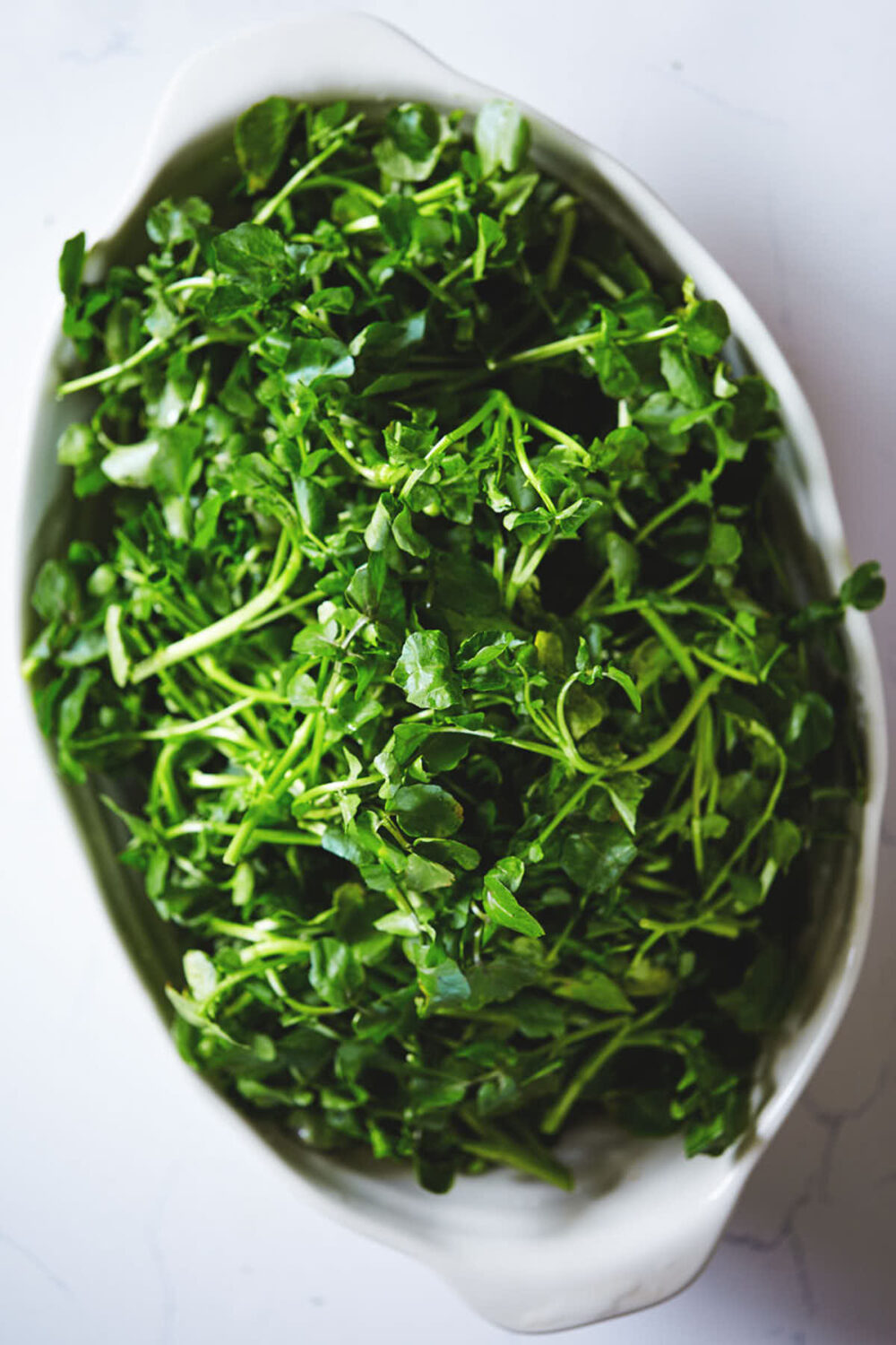 Watercress is a large bowl after being washed