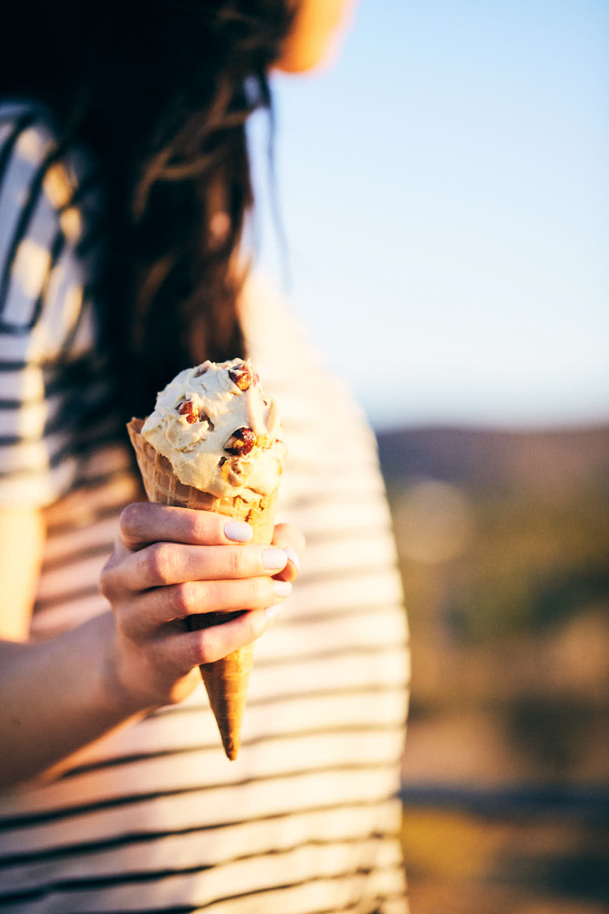 Woman holding whiskey hazelnut ice cream in the desert
