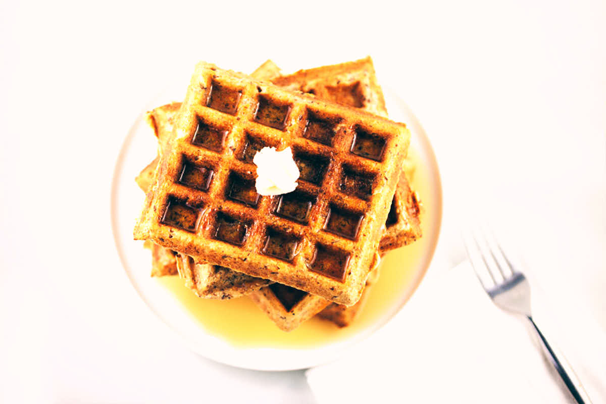 Whole wheat buttermilk waffles with maple syrup and melted butter