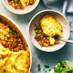 Vegetarian shepherds pie fresh out of the oven and being served into bowls