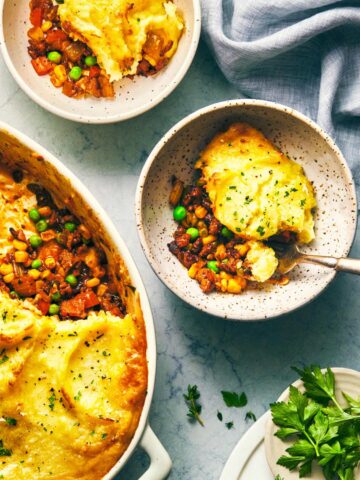 Vegetarian shepherds pie fresh out of the oven and being served into bowls