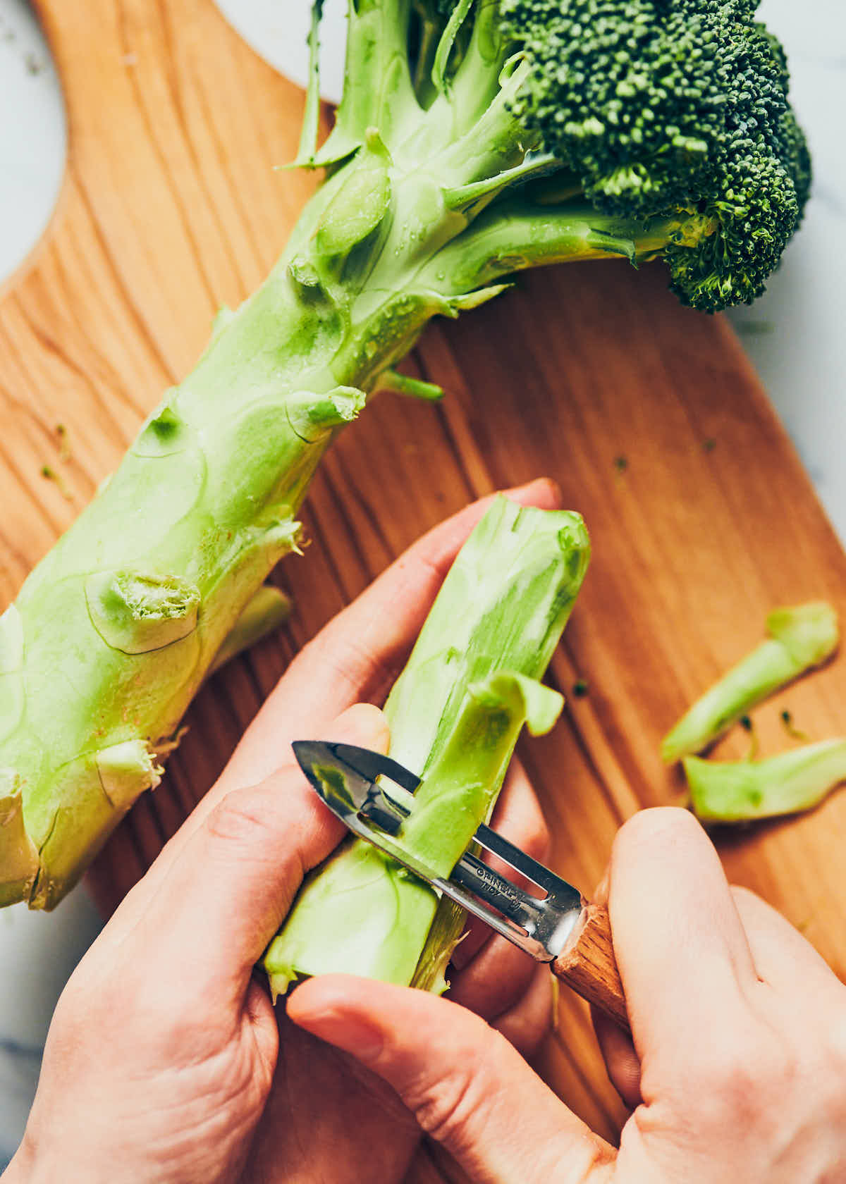Peeling broccoli stalks before cutting into fries