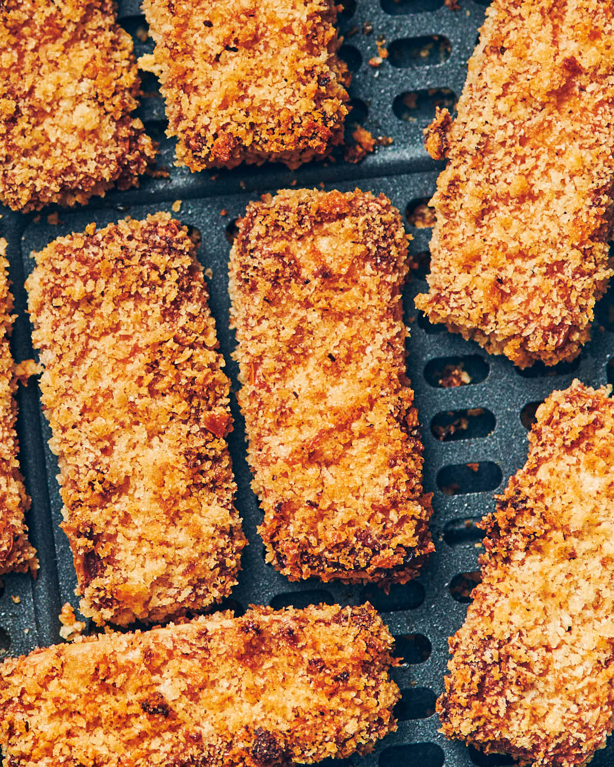 Crispy tofu sticks that are golden brown after being baked in an air fryer.