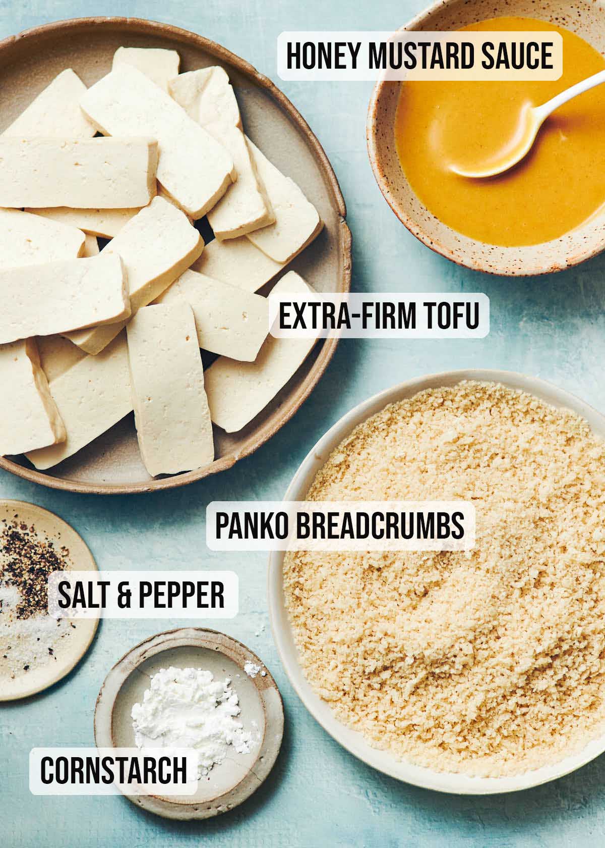 Ingredients to make crispy tofu sticks: honey mustard sauce, extra firm tofu, panko, cornstarch, salt and pepper
