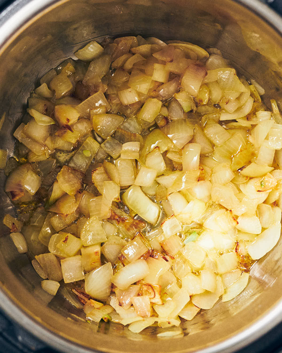 Diced yellow onions cooked in olive oil in an Instant Pot on the saute setting