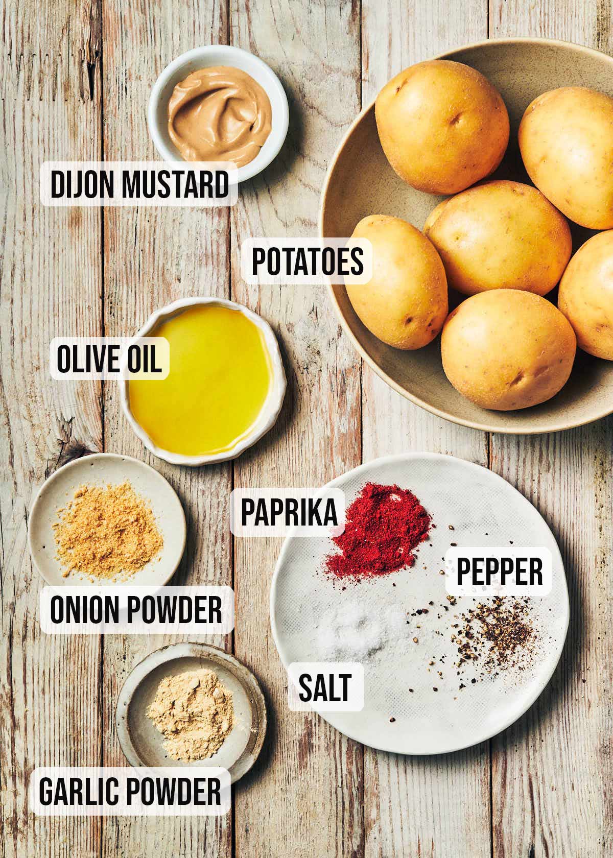 Ingredients to make air fryer breakfast potatoes (olive oil, mustard, spices, potatoes)