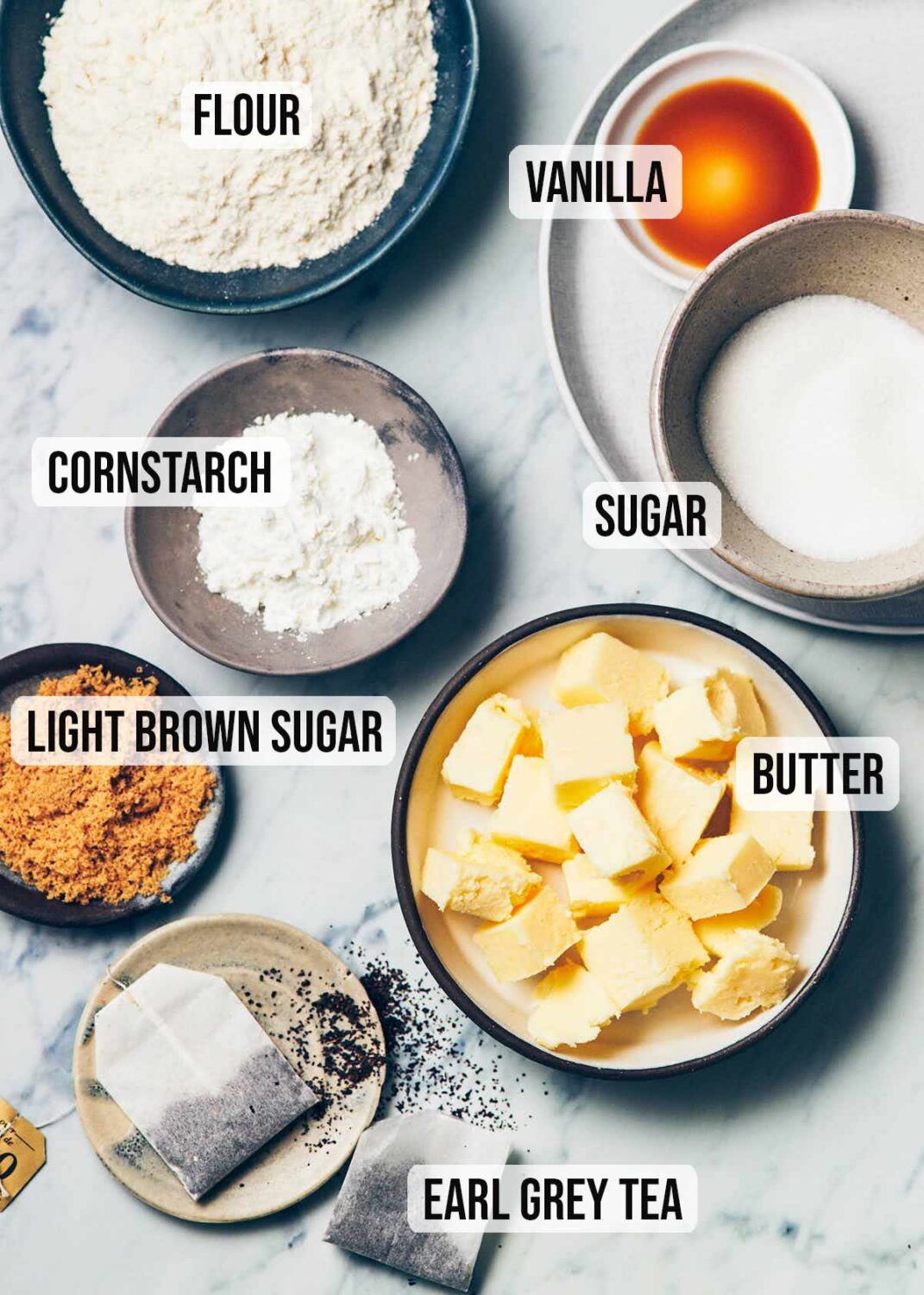 Ingredients to make earl grey shortbread (flour, vanilla, sugar, butter, earl grey tea, cornstarch)