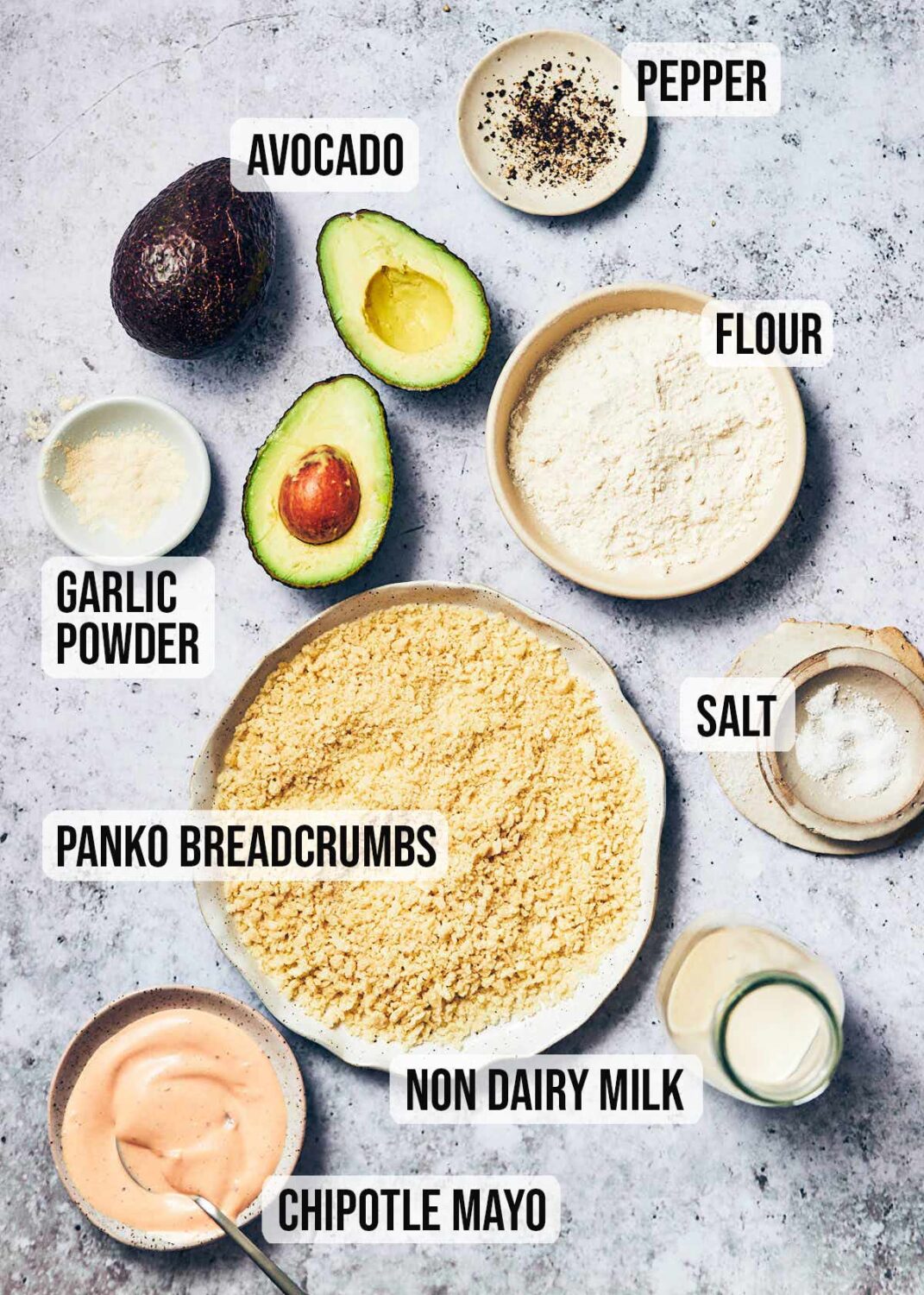 Ingredients to make crispy air fryer avocado fries: avocado, garlic powder, pepper, flour, salt, non dairy milk, panko breadcrumbs, and chipotle mayo (for dipping)