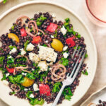 Black Lentil Salad with Feta in a bowl with a fork.
