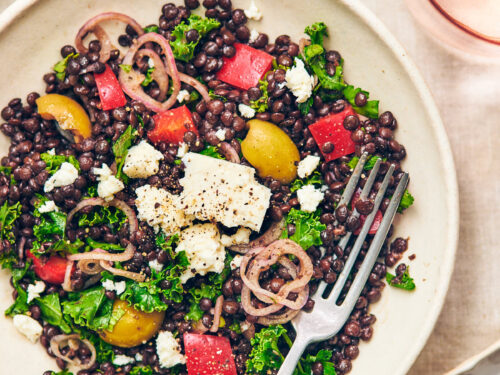 Black Lentil Salad with Feta in a bowl with a fork.