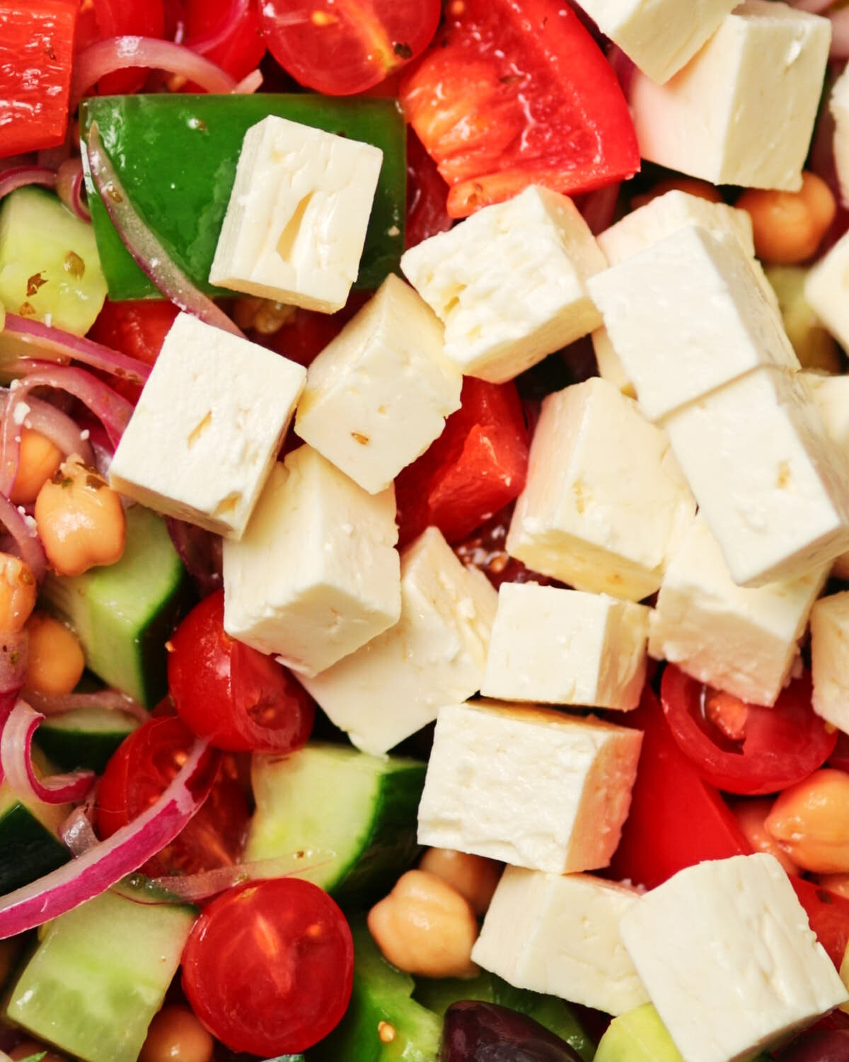 Feta cheese added to the Greek Cucumber Salad, ready to be tossed.