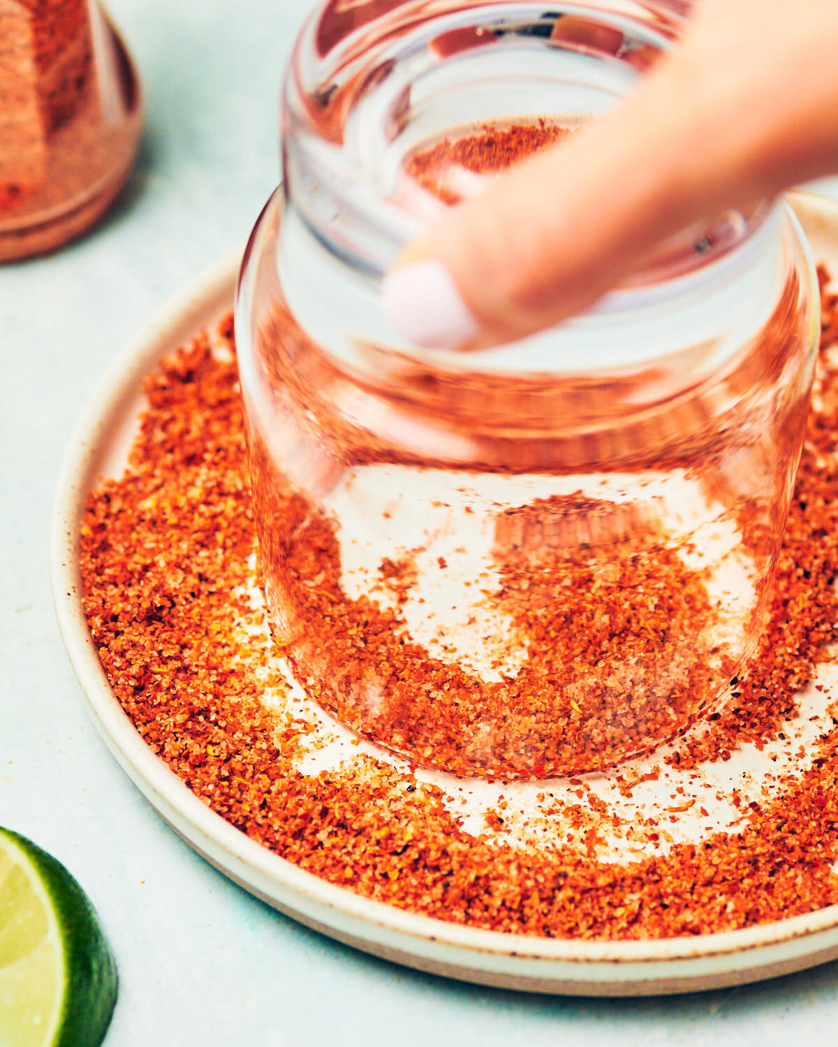 Rimming a glass with Tajin, a lime chili seasoning, for margaritas.