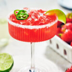 Easy Strawberry Jalapeno Margarita in a glass with fresh lime.