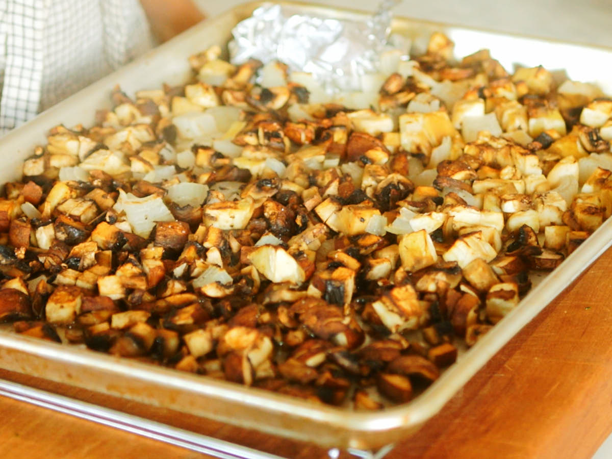 Mushrooms, eggplant, onion, and garlic roasted on a baking sheet.