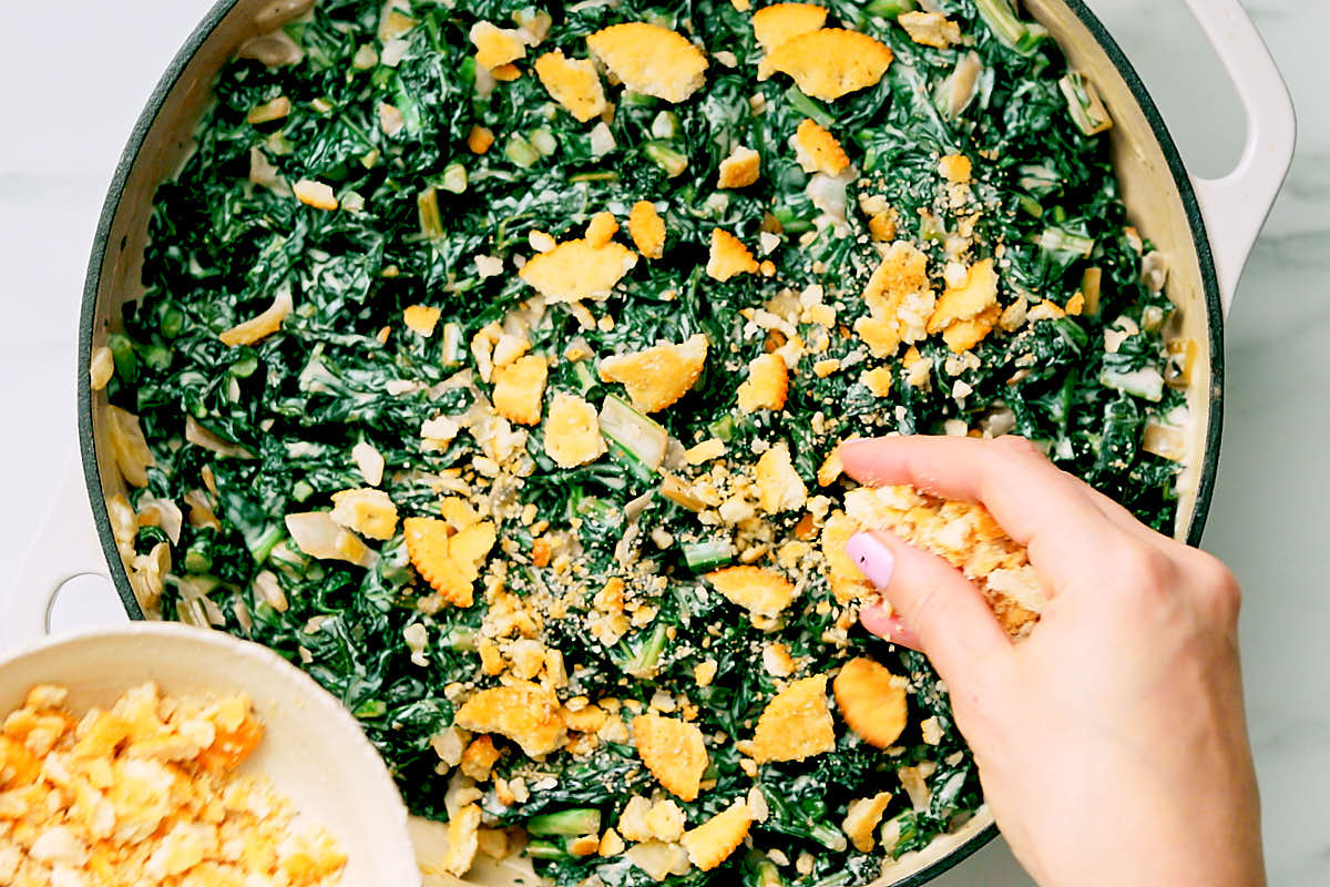 Topping easy creamed kale with crumbled Ritz crackers as a garnish before serving.