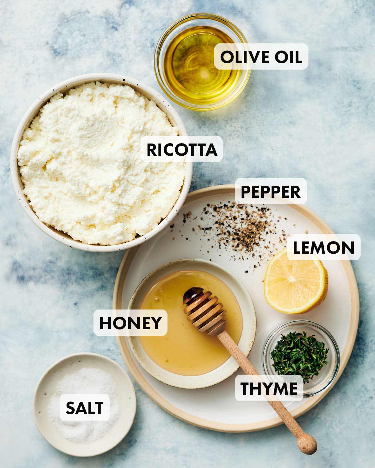 Ingredients to make whipped ricotta dip, imcluding honey and thyme.